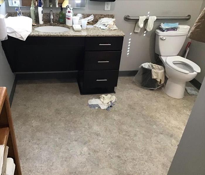 A bathroom with water damage after a pipe burst in a Barrow County home.